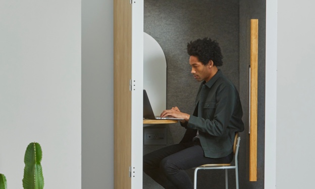 Man working on computer in cubicle