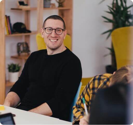 Man at desk smiling